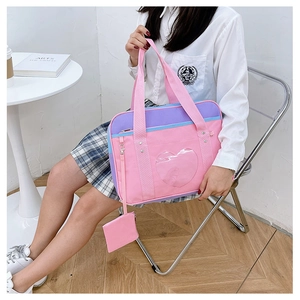 Detailed view of pink and purple travel tote bag with heart-shaped window on a model