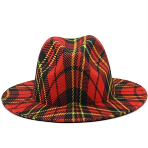 Detailed view of red and black plaid fedora hat with classic tartan texture and stitching