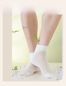Close-up of white breathable mesh ankle socks for men with a cooling summer texture