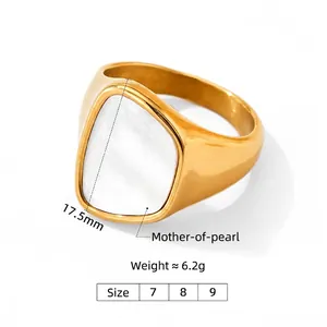 Golden stainless steel ring featuring wide white shell inlay on a white background