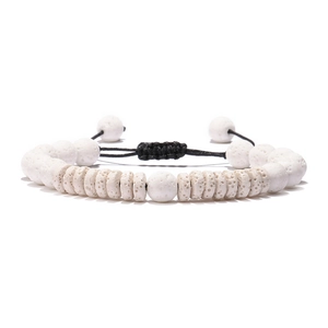 Detail of white volcanic stone beads and flat discs with black braided adjustable cord