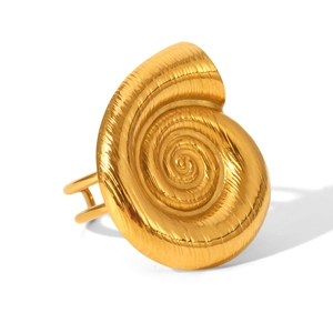Detailed close-up of golden spiral seashell ring with fine brushed metal texture