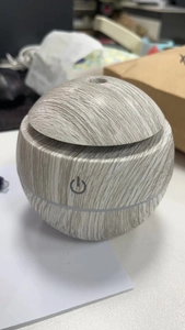 Macro detail of sphere humidifier with light wood grain finish and touch power button