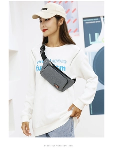 Close-up of lightweight grey oxford fabric crossbody bag with adjustable strap on model