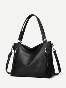 Macro detail of the black lychee texture PU leather and silver metal side zippers