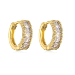 Detail showing gold huggie hoop earrings with square zircon and milgrain edges