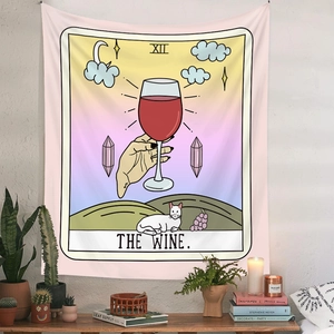 Bohemian tarot style tapestry with wine and cat art hung over a desk with plants