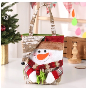 Detail of Christmas snowman gift bag with embroidery and plush fabric texture