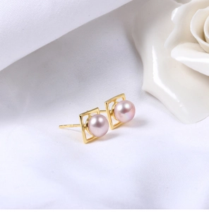 Macro detail of S925 silver square gold earrings with natural pink freshwater pearls