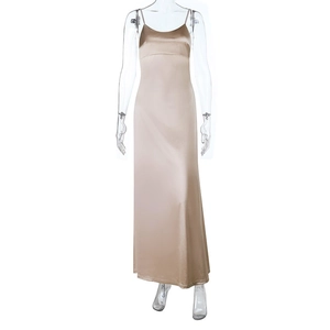 Detailed view of champagne satin dress showing fine straps and glossy silk fabric texture