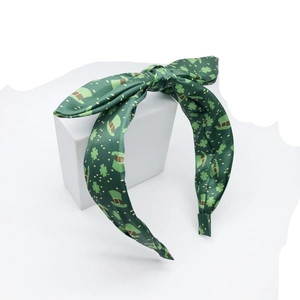 St. Patrick's Day green bow headband with clover and leprechaun hat patterns