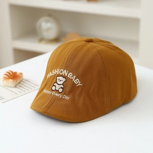 Close-up of caramel baby beret featuring bear embroidery and Fashion Baby text detail