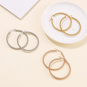 Three pairs of 39mm beaded stainless steel hoop earrings in gold, silver, and rose gold