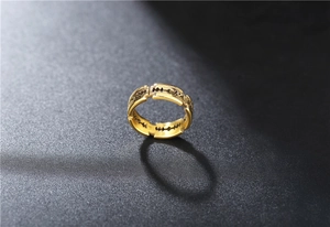 Macro shot of gold blade-shaped hollow ring made of titanium steel with industrial design