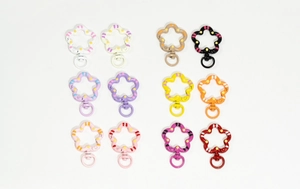 Collection of flower shaped spring ring keychains in twelve diverse colorful painted finishes