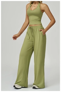 Close-up of green two-piece yoga set with halter crop top and drawstring wide-leg pants