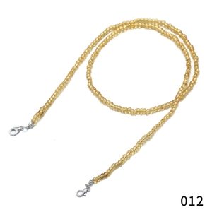 Detail view of amber yellow translucent beads and silver lobster clasps on eyeglass chain