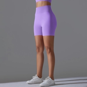 Detail showing high-waisted seamless purple biker shorts with tummy control and lifting effect