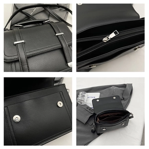 Detail of black litchi grain leather texture, silver hardware and inner zipper pocket
