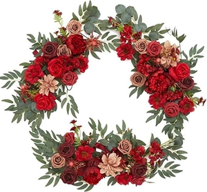Detailed view of artificial maple garland with red roses and eucalyptus leaves on white