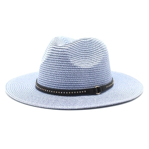Detail of light blue straw fedora showing wavy weave texture and studded black leather band