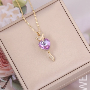 Detailed view of fox pendant with purple heart crystal and diamonds on gold chain
