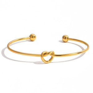 Classic 18K gold-plated stainless steel open cuff bracelet with a knotted heart design