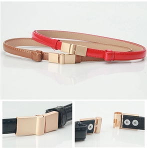 Detailed view of adjustable leather belts in red, brown, and black with gold buckles