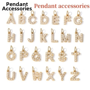 Detailed macro of 26 gold plated alphabet letter pendants with sparkling white zircons