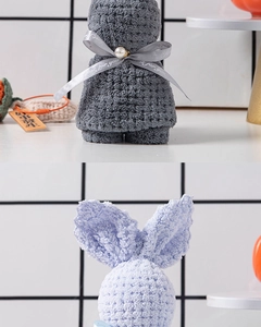 Detail of plush rabbit-shaped folded towels with 'Just for you' ribbon and pearl accent