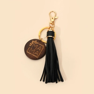 Close-up of MAMA engraved wooden pendant with black leather tassel and golden keyring