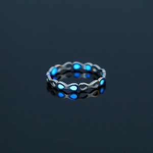 Luminous blue water drop element on silver stainless steel ring with glowing night effect