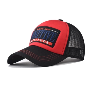 Detail of red and black mesh trucker hat with 3D Positive embroidery and curved brim