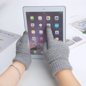 Close-up of grey touchscreen knitted gloves being used on a tablet screen in use