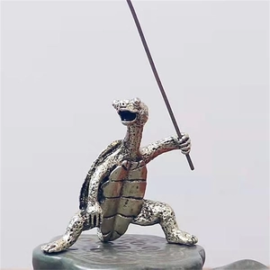 Antique silver metal turtle incense burner standing on a stone base for home decor