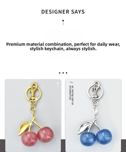Close-up of glitter cherry keychains in red and blue with lobster clasp and ring