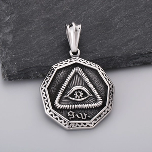Macro detail of silver stainless steel octagonal pendant with All-Seeing Eye design