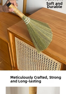 Detail of a handmade natural fiber broom cleaning a wooden surface with soft bristles
