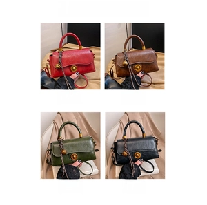 Detail showing vintage faux leather handbags in four colors with gold turn-lock closures