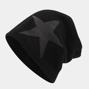 Detail of black knit beanie featuring thick fleece lining and grey star jacquard pattern