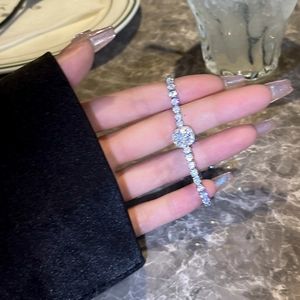 Close-up of elegant silver sparkling zirconia heart bracelet on a woman's wrist