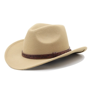 Detail of khaki western cowboy hat with embossed floral pattern on brown leather band