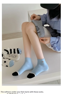 Detailed view of women's ribbed ankle socks with patterns, black polka dots and stripes