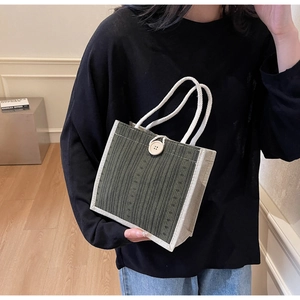 Detail view of mini linen tote bag in army green and beige with woven rope handles