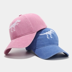 Washed cotton baseball caps with embroidered dinosaur skeleton in pink and blue colors