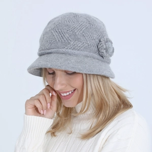 Detail view of a gray knit floral bucket hat on a model for winter fashion styling