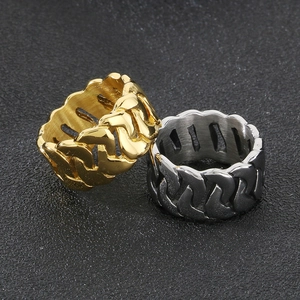 Detailed macro view of wide Cuban link chain rings in gold and silver polished steel