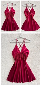 Detail of wine red satin nightgown featuring deep V-neck lace and cross back straps