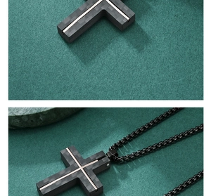 Detail of cross pendant with carbon fiber texture and gold accents on black chain