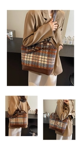 Macro view of vintage plaid tweed tote bag with premium brown leather trim and handles